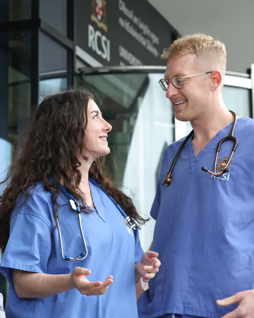 Medical students and tutor outside university building