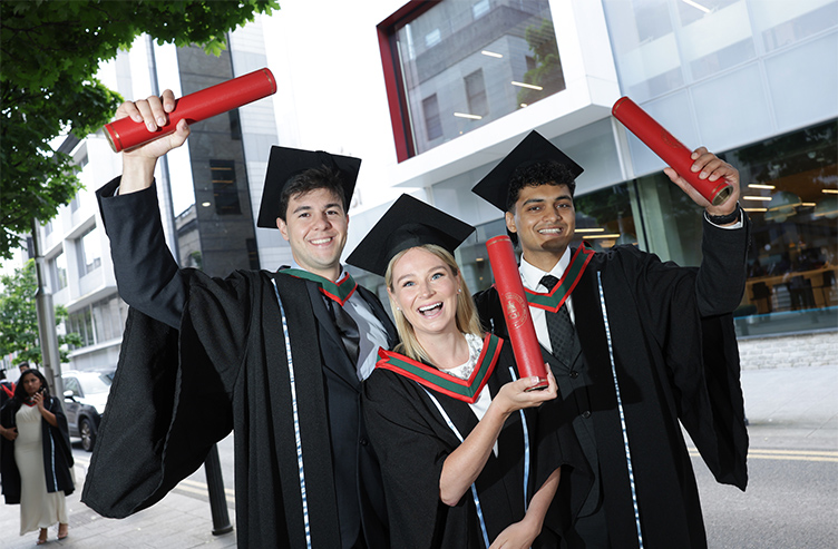 Three Medicine students celebrate their conferring outside 26 York Street. 