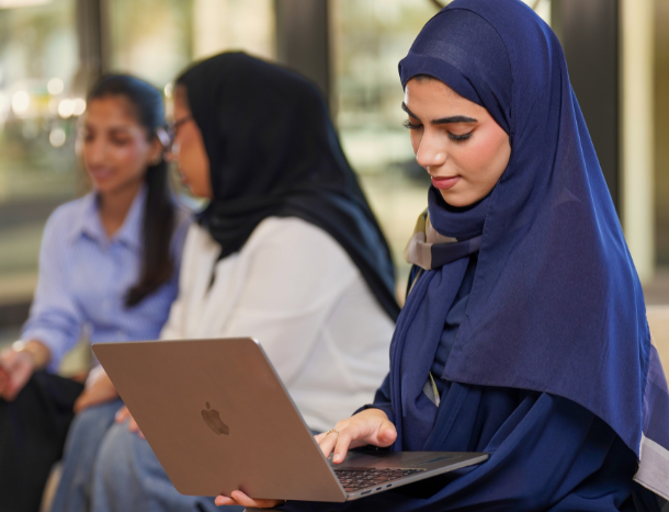 A student using a laptop to schedule a meeting.