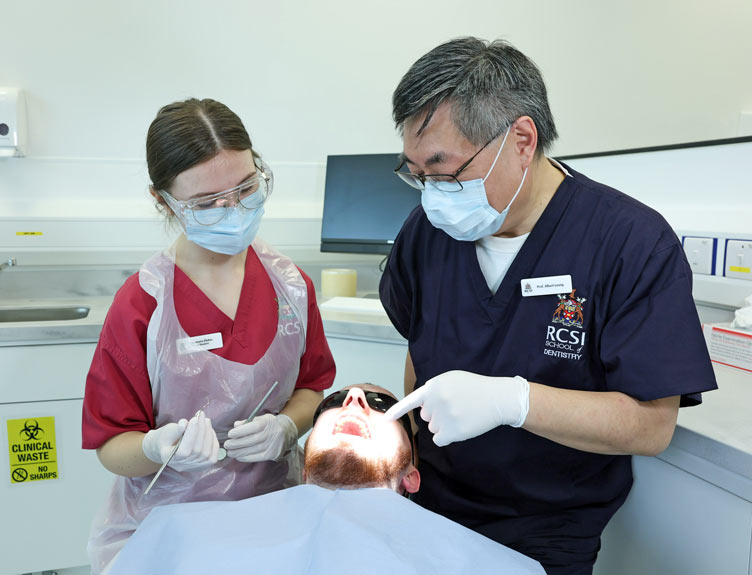 Professor Albert Leung with a dental student treating a real patient
