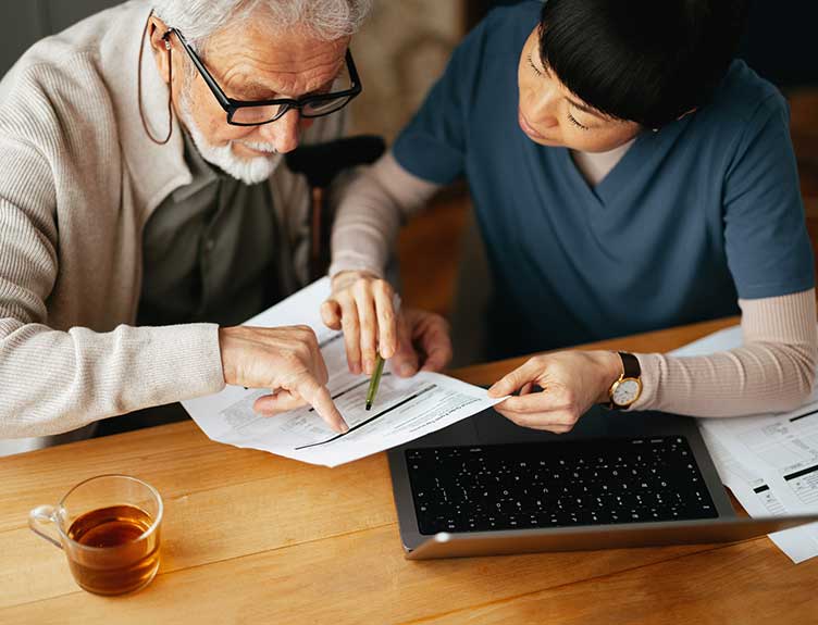 Healthcare working assisting elderly man