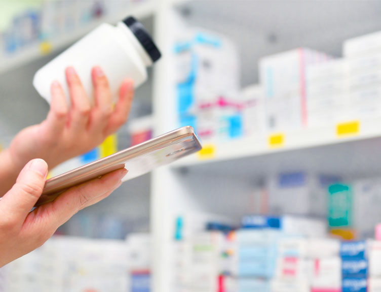 Pharmacist examining bottle