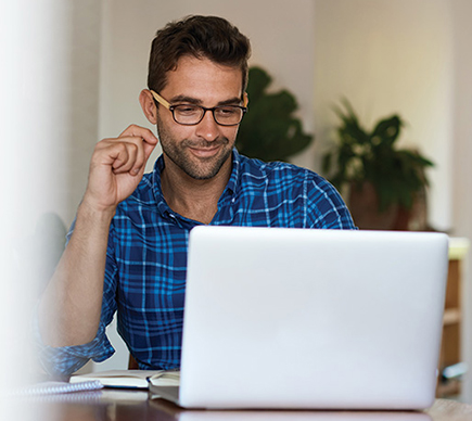 A professional working at a laptop computer.