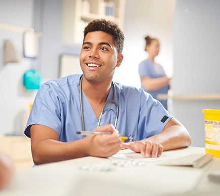 A medical professional working on a patient's file.
