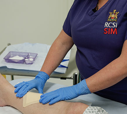 Nurse treating leg wound