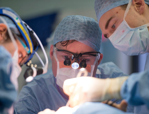 Three surgeons operating
