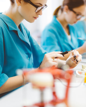 Students learning dentistry at prosthodontic lab