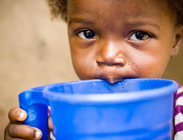 Child drinking water in Africa