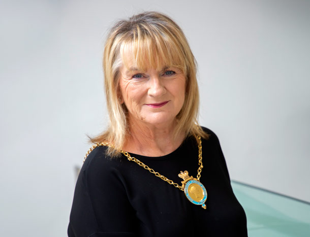 A lady poses for a professional headshot photograph