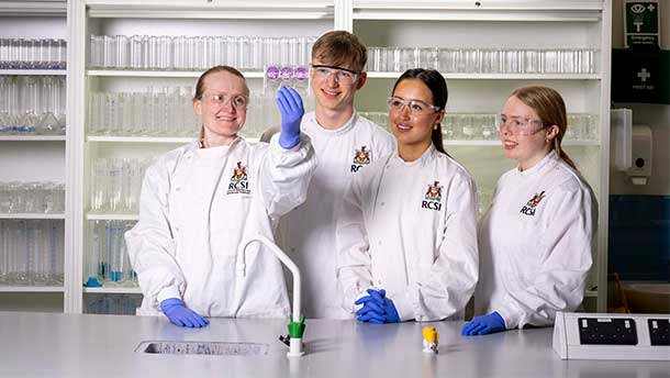 Three RCSI ATT students pictured with tutor in lab environment