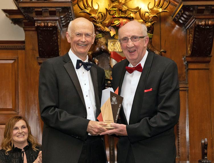 Professor Michael Farrell A man is presented with an award at a ceremony