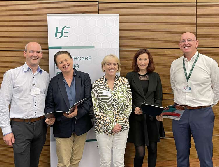 Standards for Acute Surgical Assessment Units Five people stand in front of a HSE banner