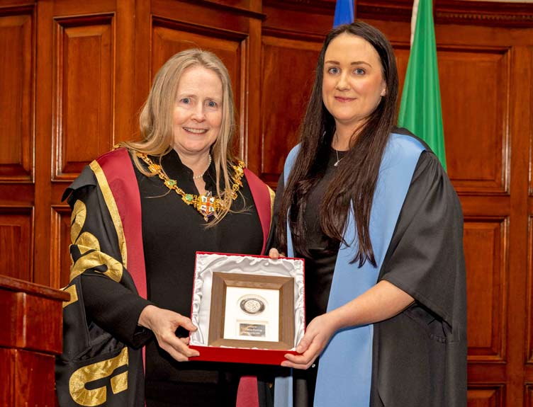 Millin Lecture 2024 Two academics pose with a plaque