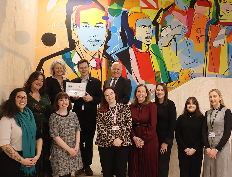 Group of RCSI staff members celebrates RCSI being named an Autism Friendly Higher Education Institution with Adam Harris CEO and Founder of AsIAm