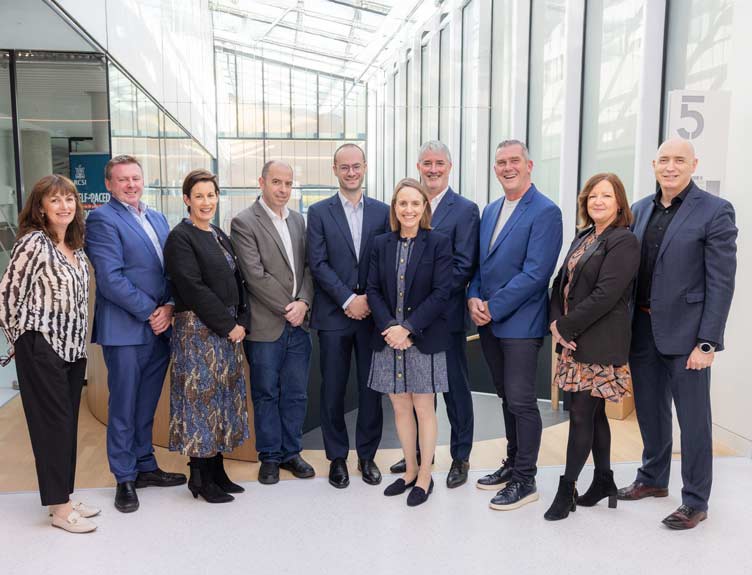 A large group pose in well-lit building during launch of new Entrepreneur in Residence programme