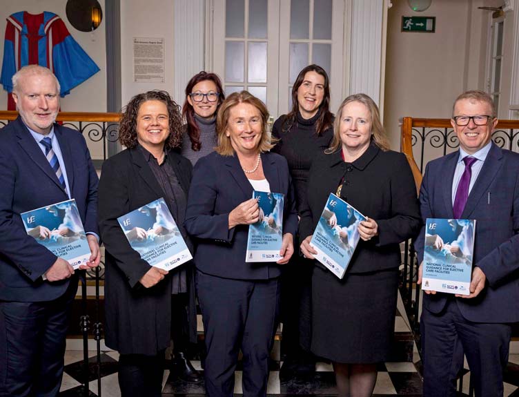 Large group of medical professionals hold printed publications