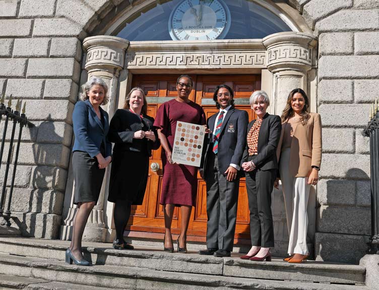 Race Equality Action Plan 2025-2029 launch Group of five individuals in front of historic building at launch of a publication