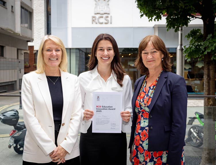 RCSI Education Innovation Award 2025 Award winner poses with certificate and two individuals