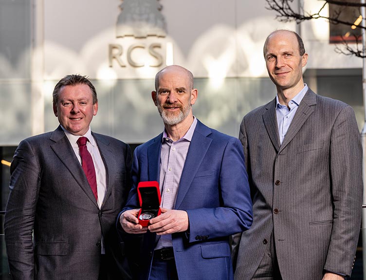 RCSI Research Day One individual being awarded by two other individuals