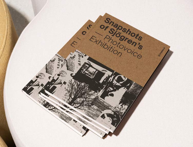 Copies of booklets for Sjögren’s exhibition sit on a desk