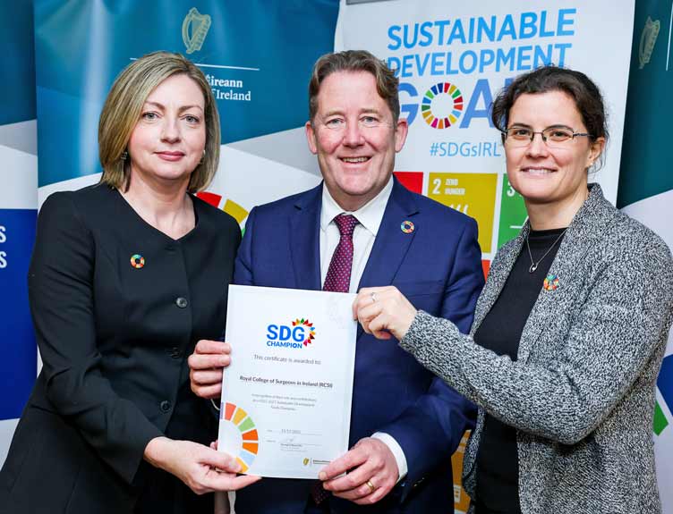 Three professionals hold a Sustainable Development Goal Champion certificate