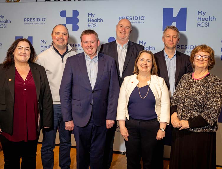A health discussion panel pose in front on MyHealth RCSI branding