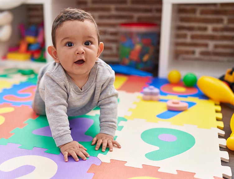 Lockdown babies A baby crawling on the floor at a creche