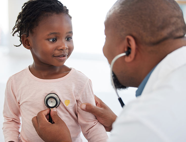 Paediatrician A paediatrician examines a baby girl with a stethoscope
