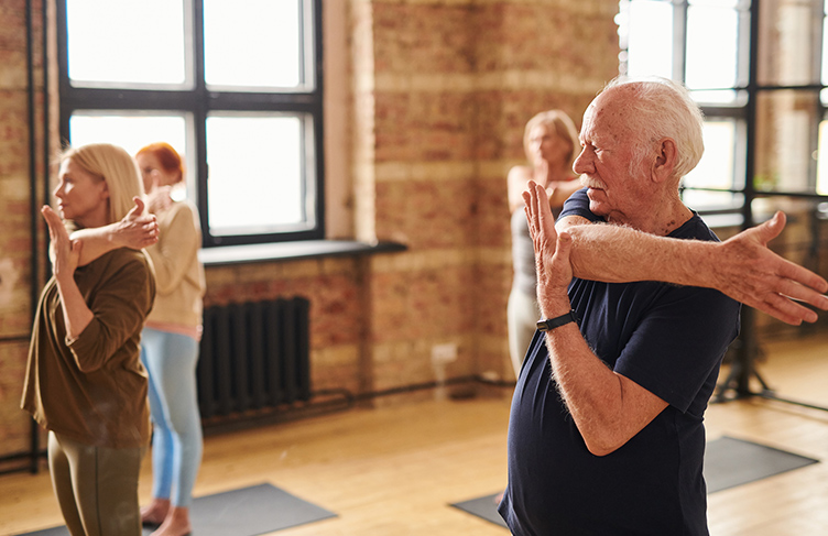 Senior man taking part in yoga class