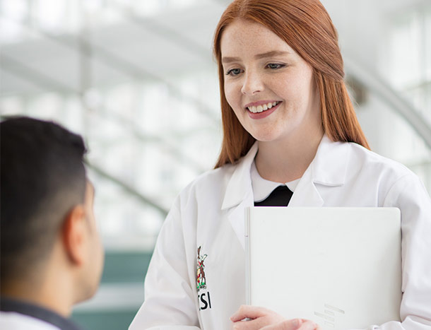 Female RCSI student in white coat
