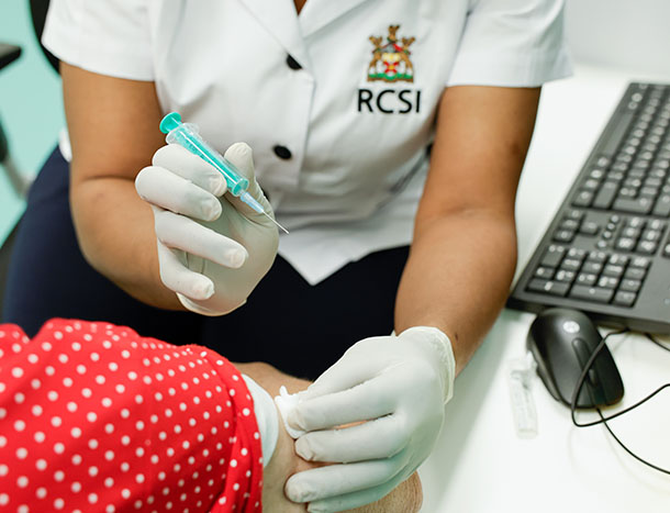 Nurse giving elderly woman an injection