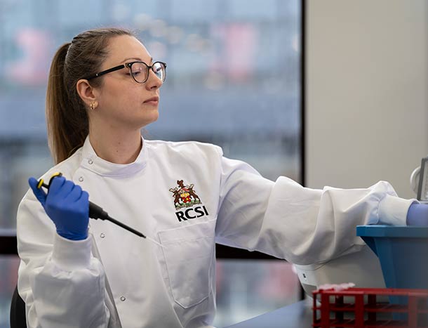 RCSI researcher pippettes in a laboratory