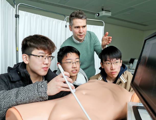 RCSI students with simulation teacher