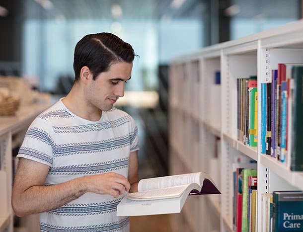 Undergraduate student reading book in Library