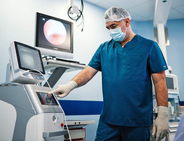 Doctor preparing instruments and the medical room for the surgery