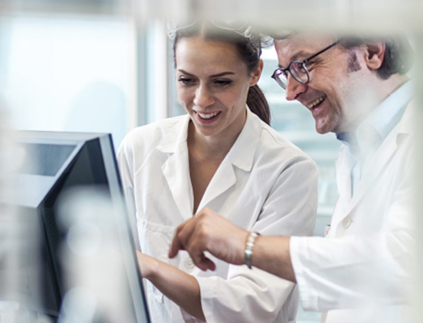 Two researchers looking at screen