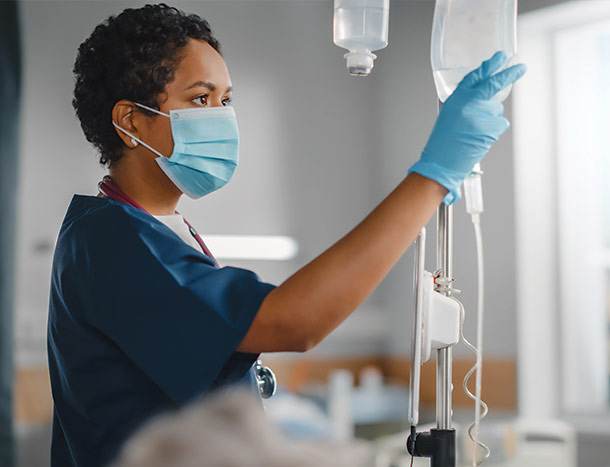 Nurse checking patients drip