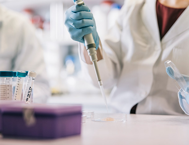 Scientists taking samples with pipette