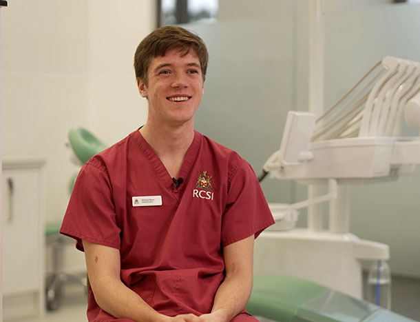 Headshot of Nicholas Meara wearing scrubs and pictured in RCSI Dentistry teaching lab. 