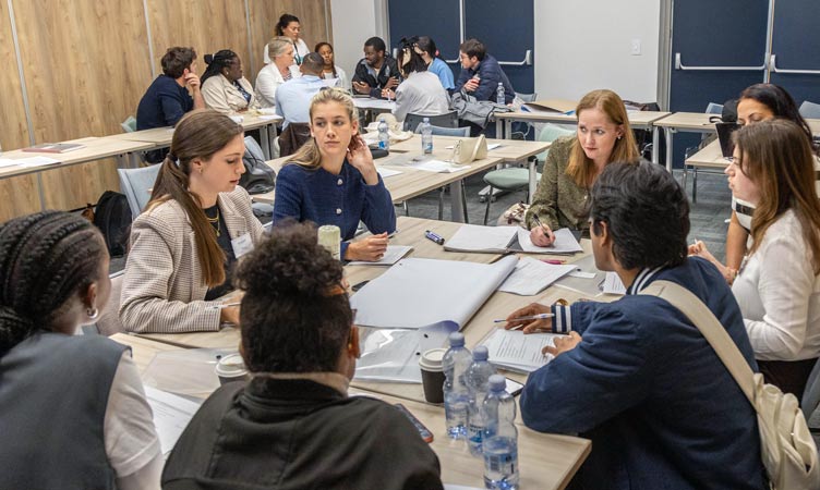 Group of students and tutor in discussion