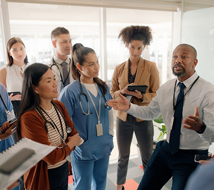 A group of healthcare professionals listening to a briefing.