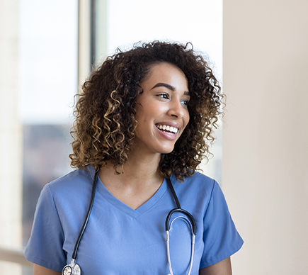 A young doctor, smiling.