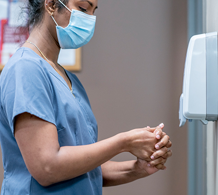 A nurse washing their hands.