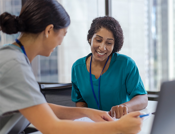 Medical professional colleagues confer over a file