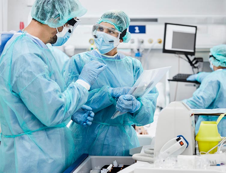 Two medical staff in protective equipment talking Two medical staff in protective equipment talking