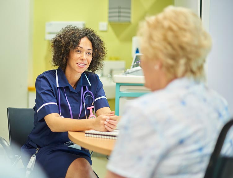 Nurse interacts with patient in hospital