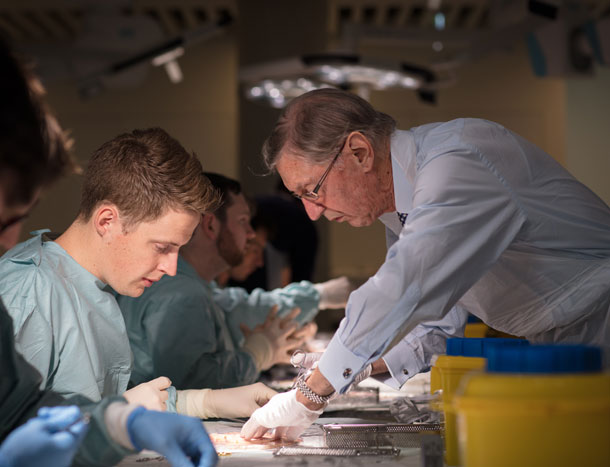 Surgical trainee and trainer in wet lab