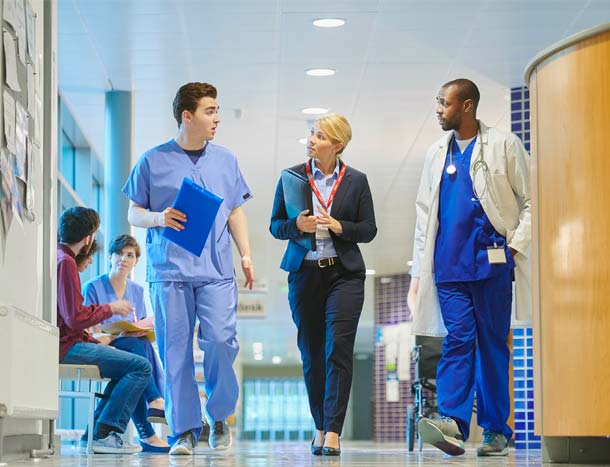 Doctors and hospital management in hallway
