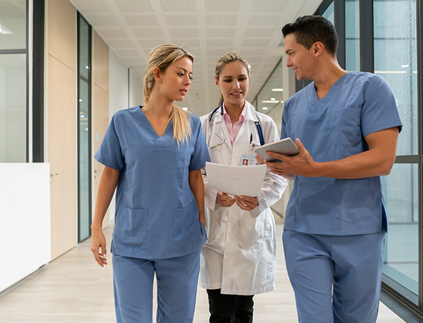 Three doctors in hospital hallway